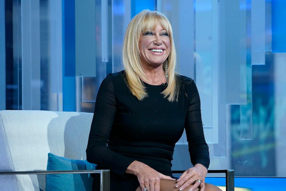 Suzanne Somers smiling on couch