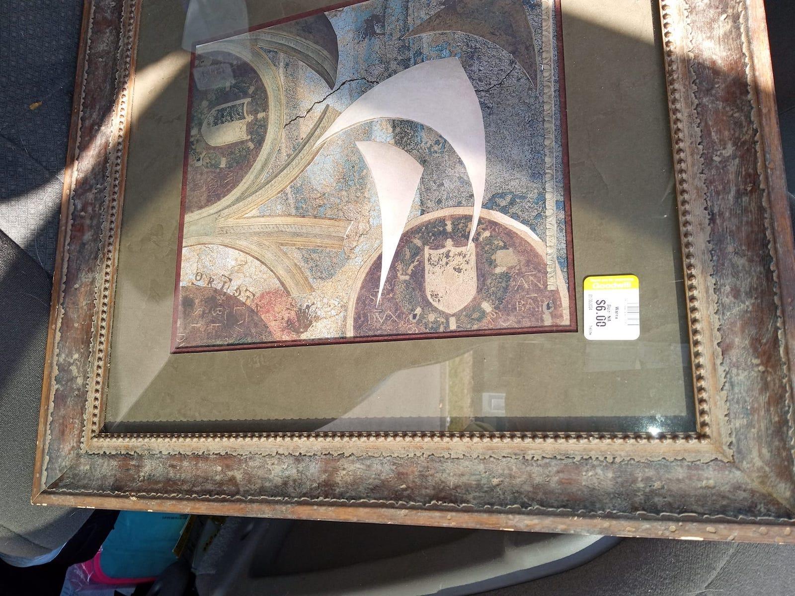 Framed collage by Beth S. Zamarripa sitting on a car seat.