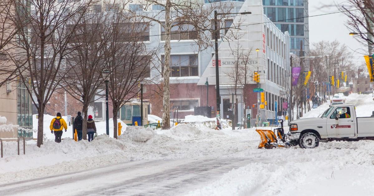 A plow is seen clearing a busy street