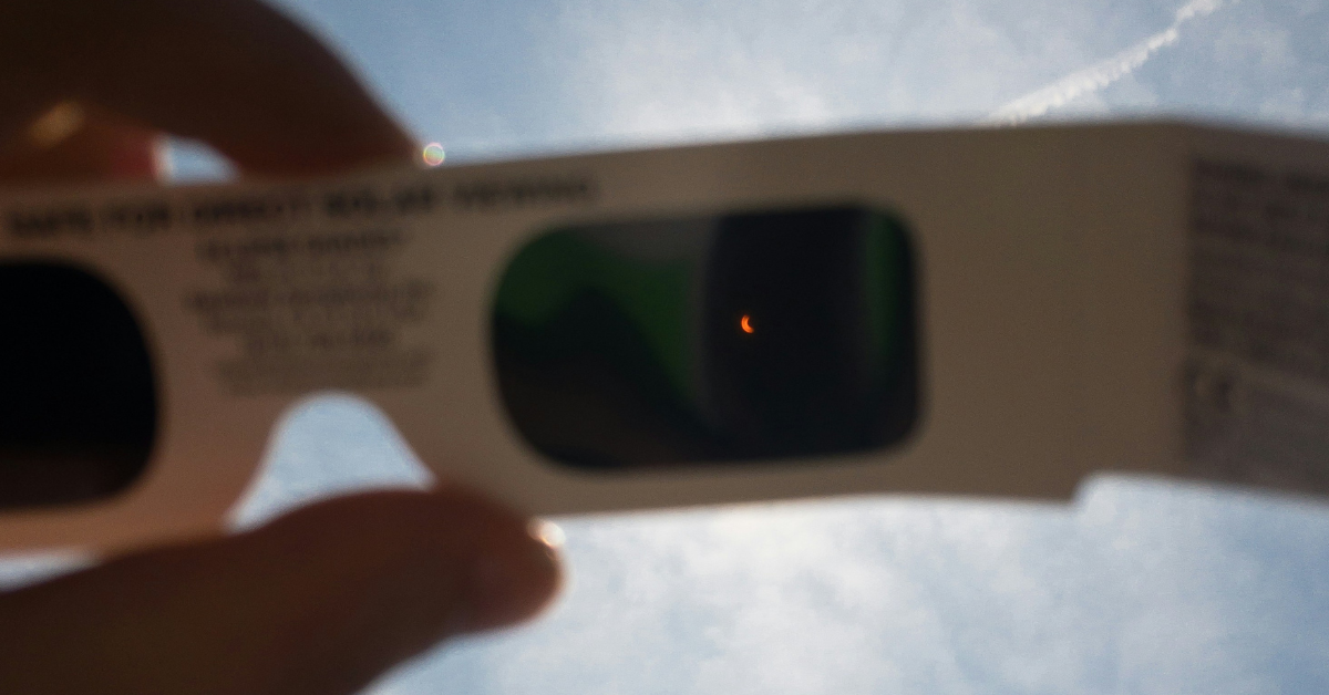 A closeup of the view of an eclipse as seen through eclipse-safe glasses
