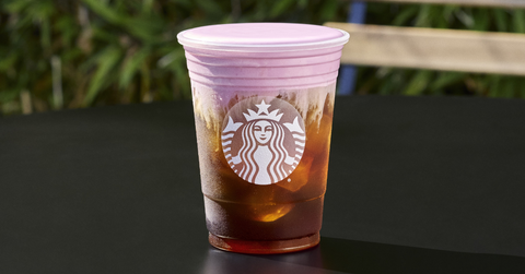 A closeup of a cold brew coffee topped with raspberry syrup