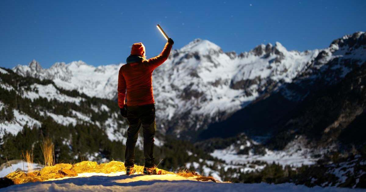 A man using a torch to climb the mountains at night. (Representative Cover Image Source: Pexels | Marek Piwnicki)