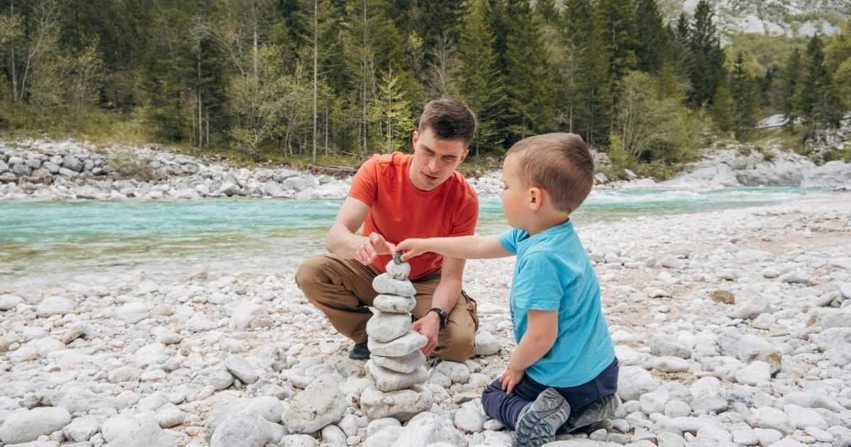 A father-son duo is making a rock stack on a riverbed. (Representative Cover Image Source: Getty Images | Westend61)