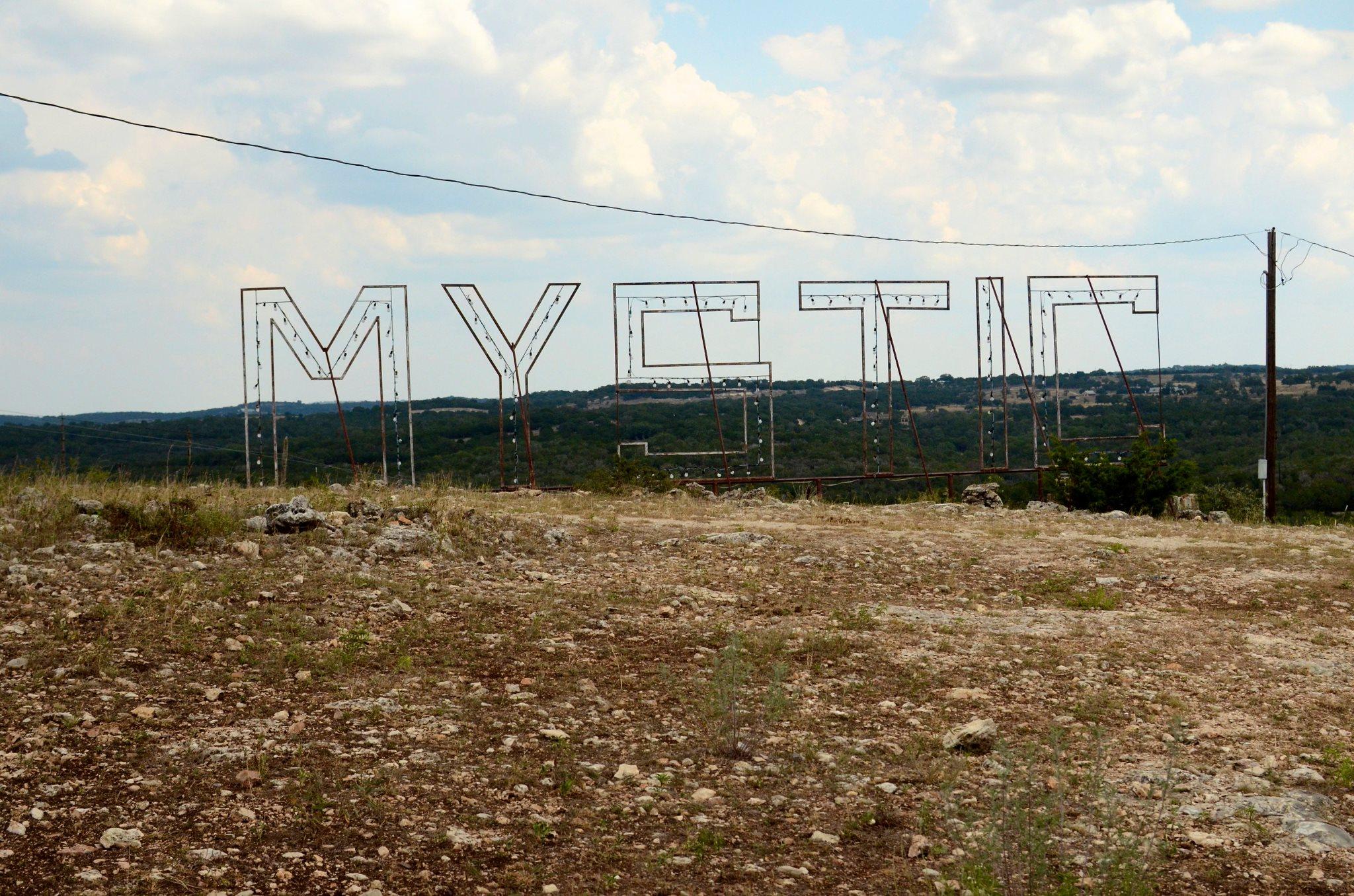 The word "Mystic" is pictured in wire and string lights at the Camp Mystic grounds.