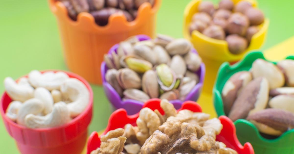 Bowls of nuts that could potentially cause allergies, such as cashews, walnuts, and almonds.