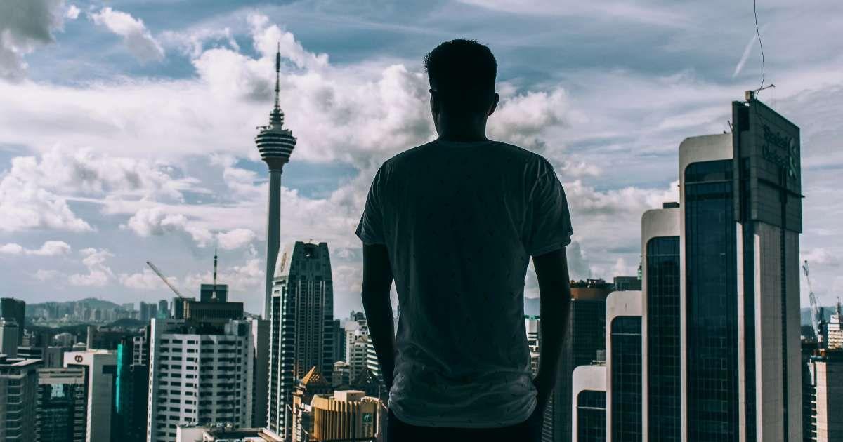 A man looking at buildings. (Representative Cover Image Source: Pexels | Adil Alimbetov)