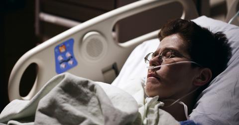 A man lays in a hospital bed