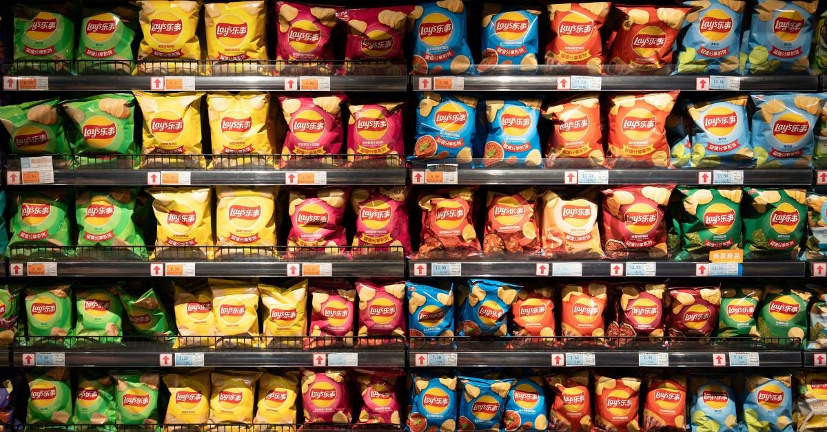 A wall of Frito-Lay products lines shelves at the grocery store