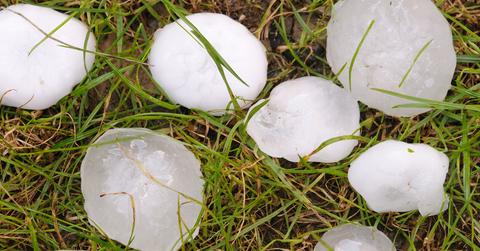 Stock photo of large hail balls on ground.
