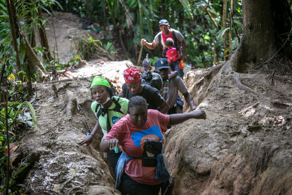 A group of a few Haitian migrants moving through the jungle during their journey through the Darien Gap.