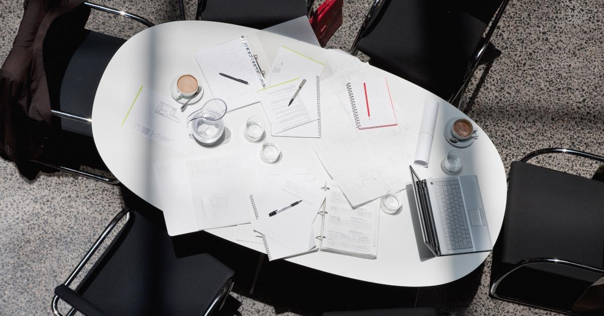 Empty office space with notepads and laptops.