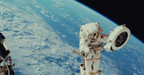An astronaut doing a spacewalk looks at the Earth. (Representative Cover Image Source: Unsplash | NASA)