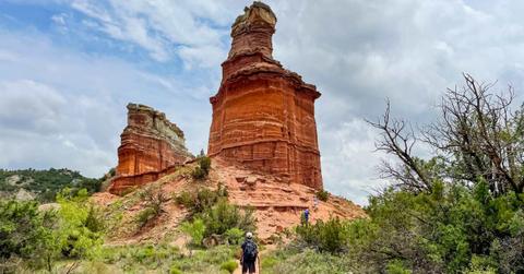 A visitor walking towards the lighthouse symbol rock in Palo Duelo State Park in Texas (Representative Cover Image Source: Getty Images | Fang Zheng)