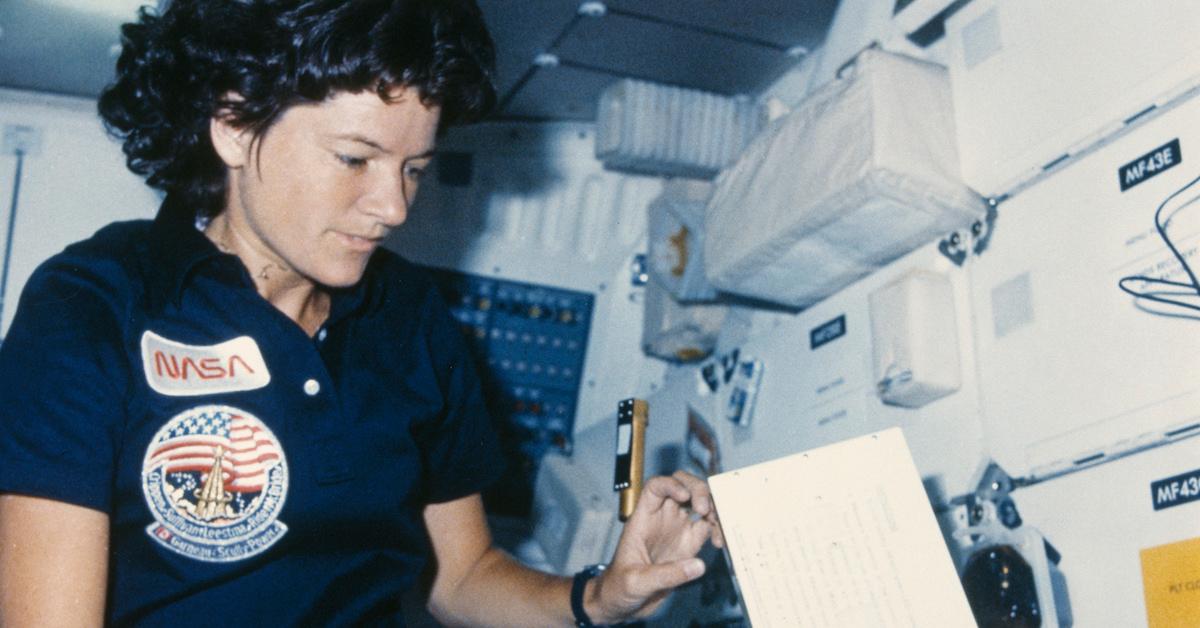 NASA astronaut Sally Ride reaches for a paper in the interior of the Challenger space shuttle during the STS-41-G mission, October 1984.