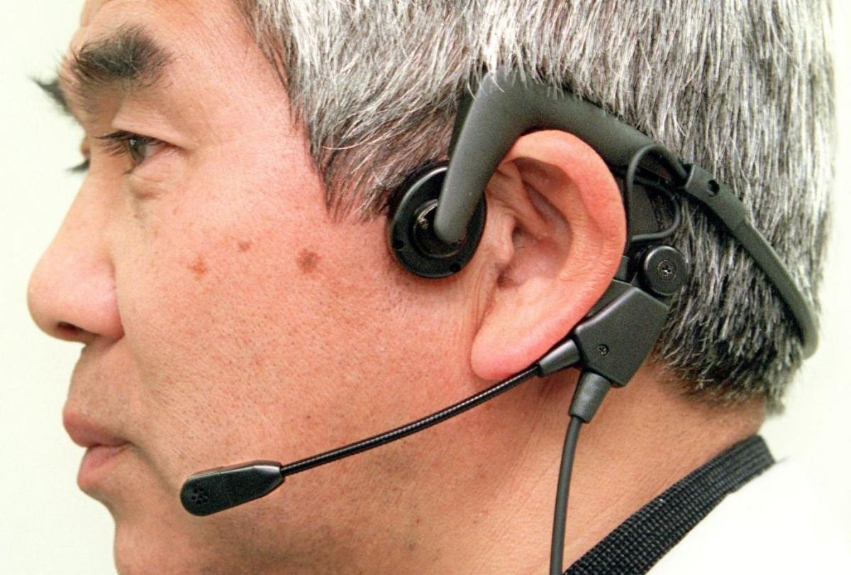 man demonstrating bone conduction headphones