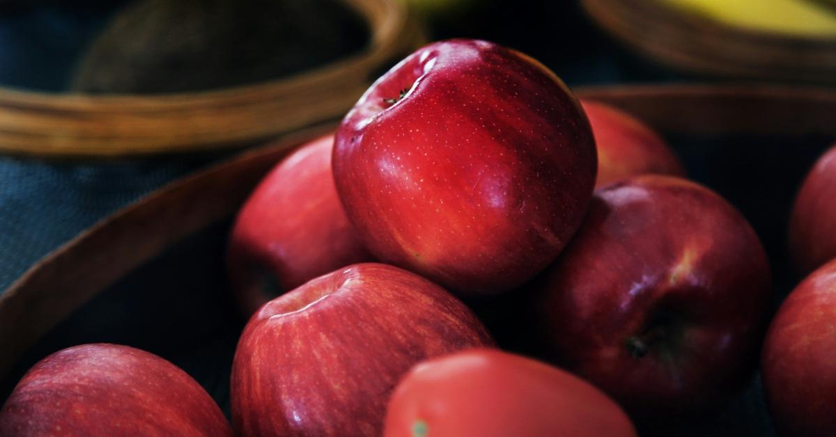 Basket of red apples on a blue table. 