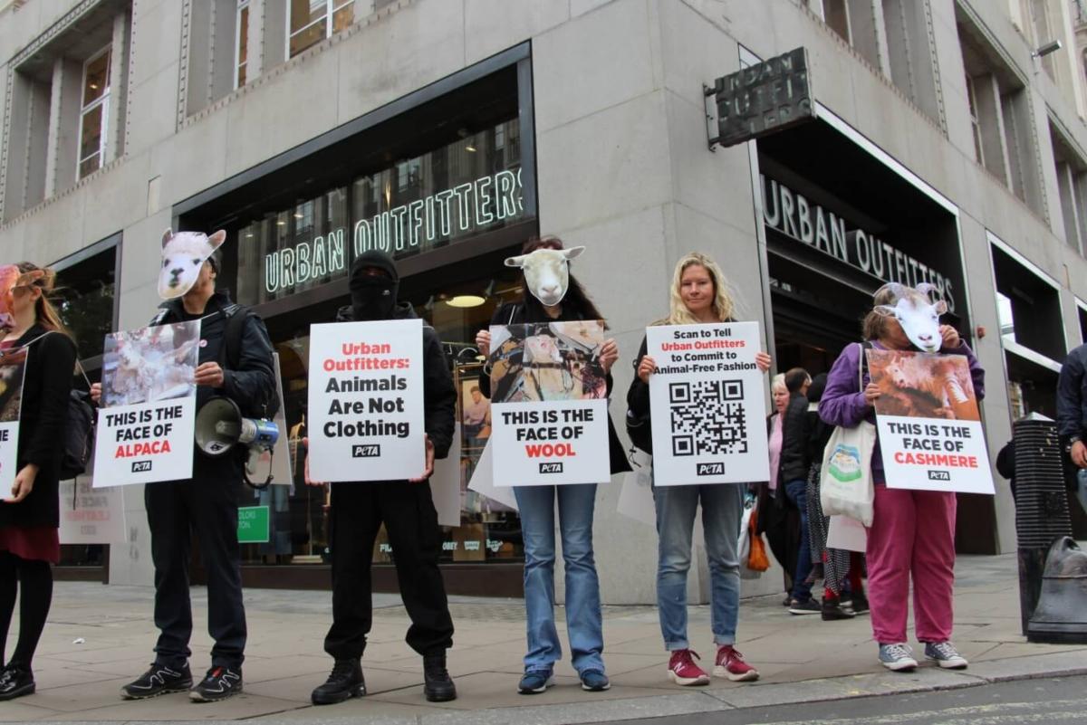 London, England, UK. 23rd Mar, 2022. PETA activists wearing snake costumes  and covered in fake blood were 'skinned alive' outside the Louis Vuitton  store in New Bond Street in protest against the