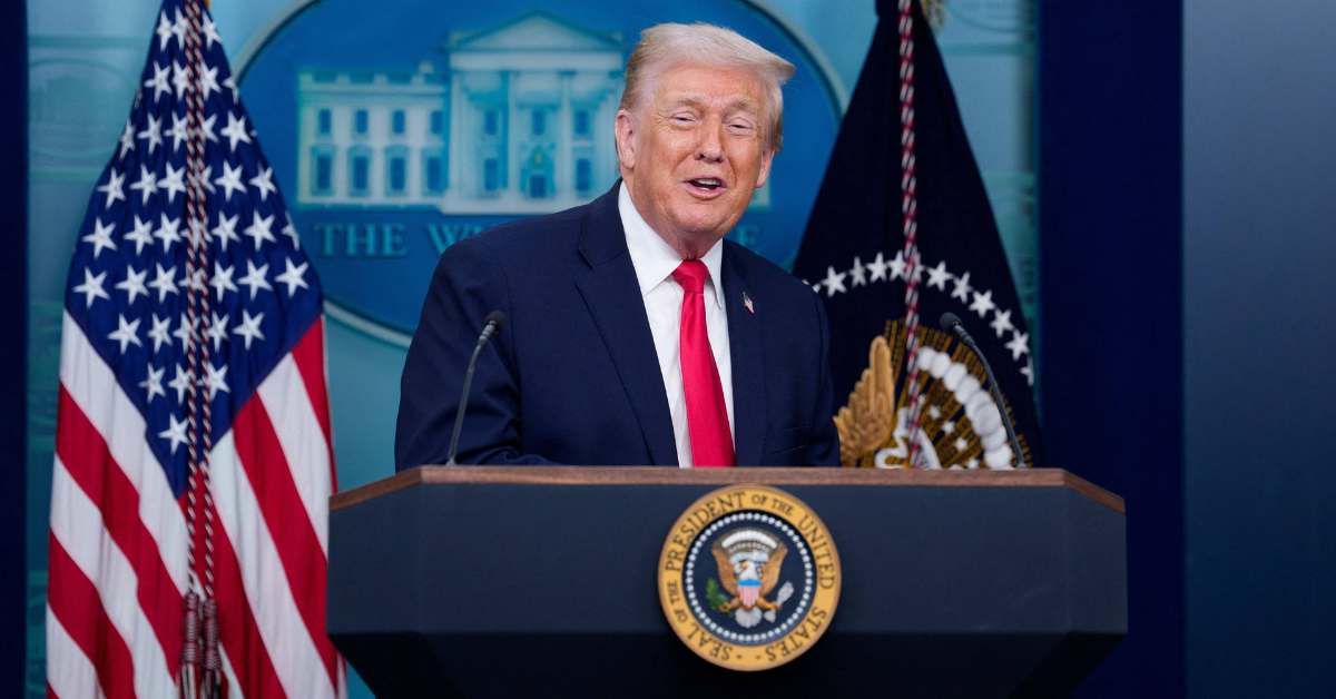 Donald Trump addresses reporters from behind the presidential seal
