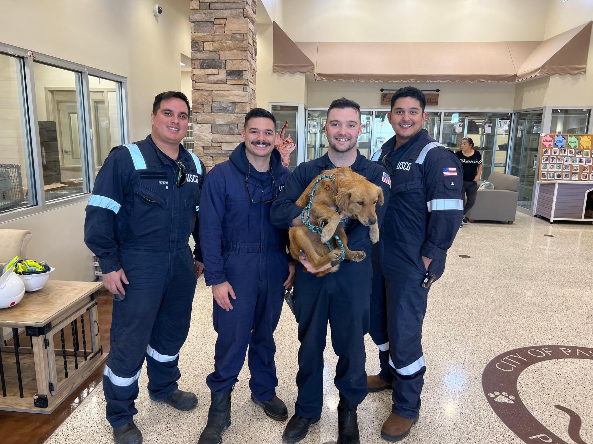 MST3 Bryan Wainscott, MST1 Lucas Loe, MST2 Ryan McMahon, and MST3 Jose Reyes pose with Connie the Container Dog.