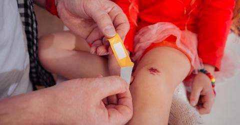 doctor putting bandaid on cut