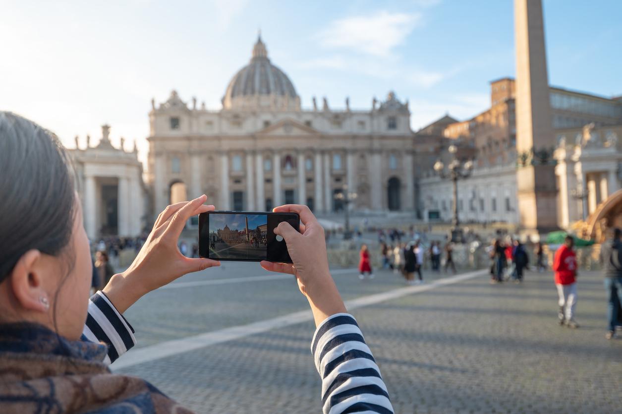 Person taking photo outside with phone.