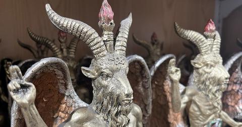 Two statues of Baphomet, a pagan deity that resembles a goat, stand next to each other.