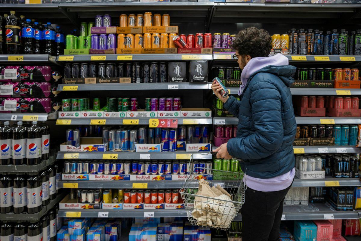 Man shopping for energy drinks at the grocery store