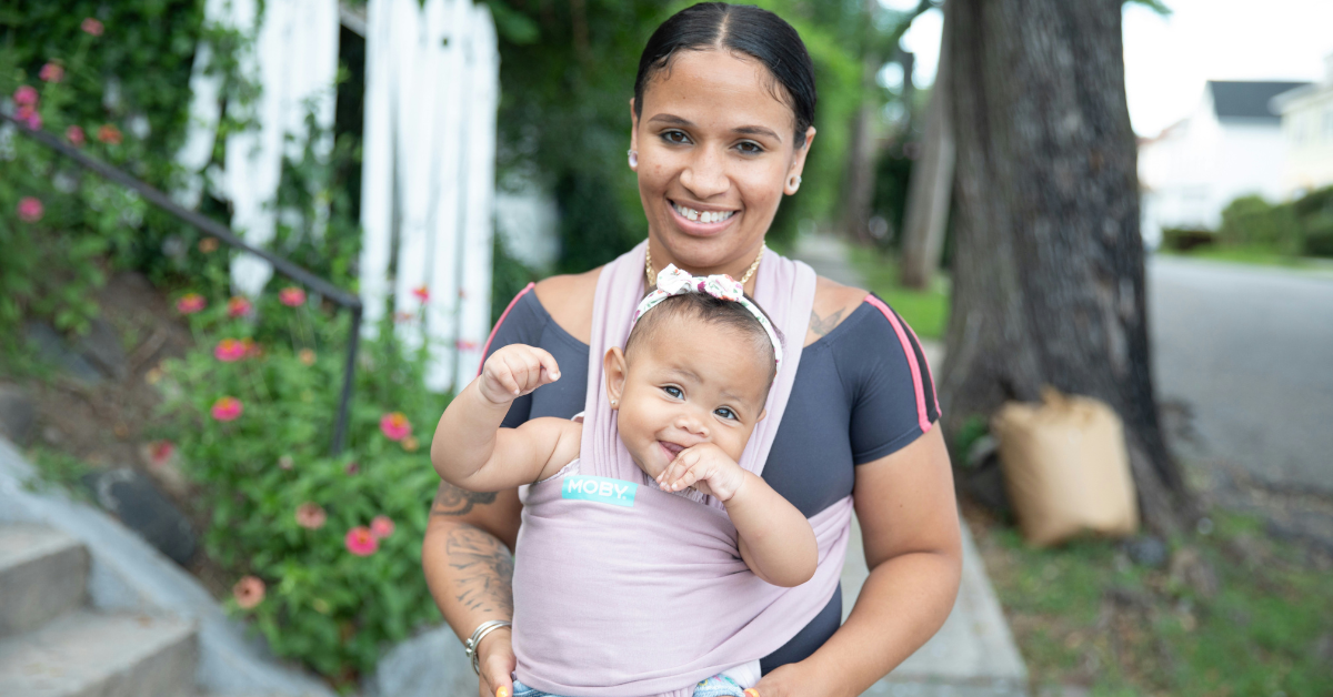 A mom wears her baby in a Moby wrap