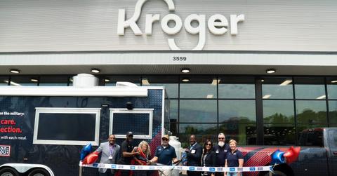 A ribbon cutting ceremony takes place in front of a Kroger store.