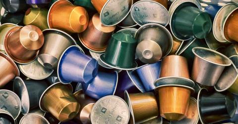 Many plastic coffee pods are stacked atop one another.