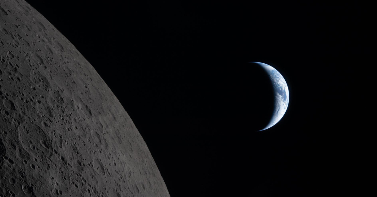 A sliver of the Earth is visable from behind the moon