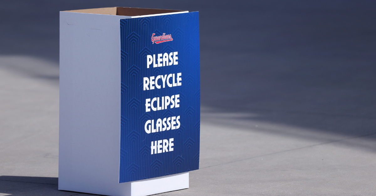 A recycling bin is placed outside for people to donate used solar eclipse glasses