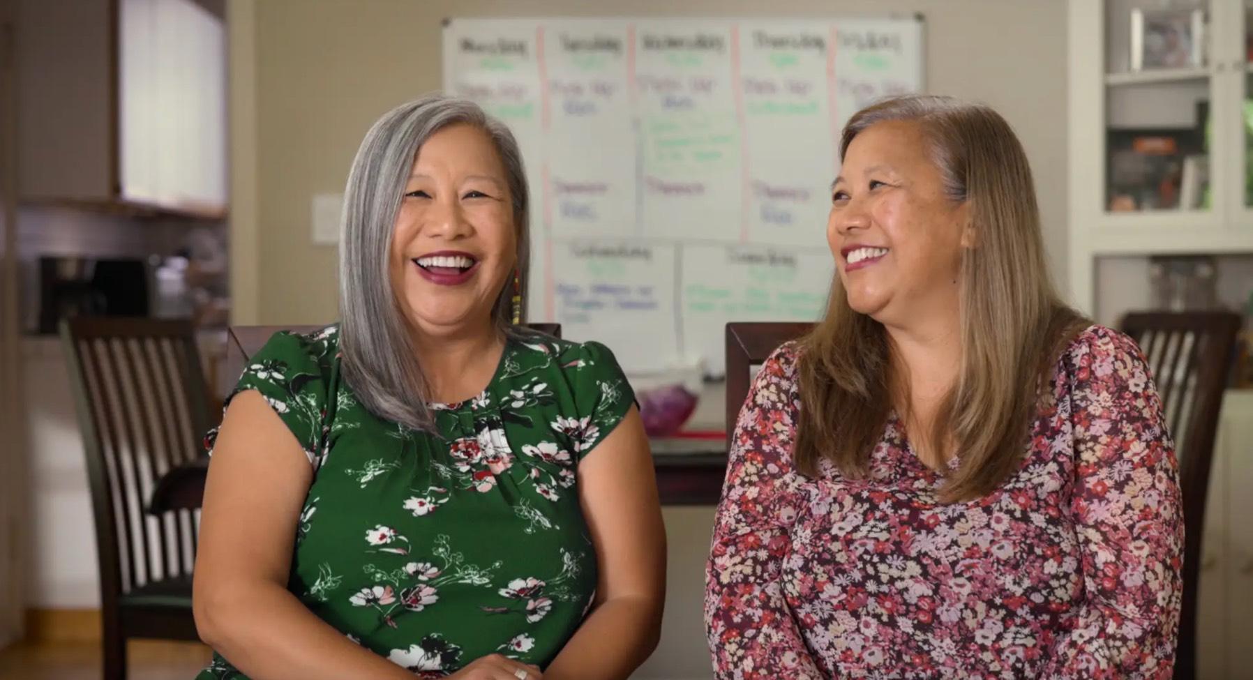 Twins Carolyn and Rosalyn pose together in gray and pink shirts while eating strawberries and toast in the trailer for the new Netflix documentary series in which they star.