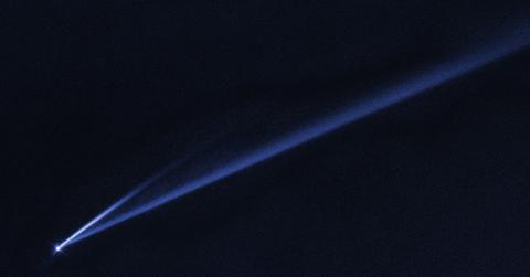 An asteroid streaks through the night sky