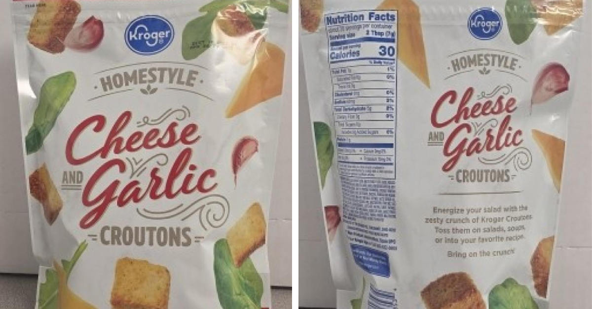 The front and back of the packages of the recalled Kroger cheese garlic croutons appear as the bag sits on a counter