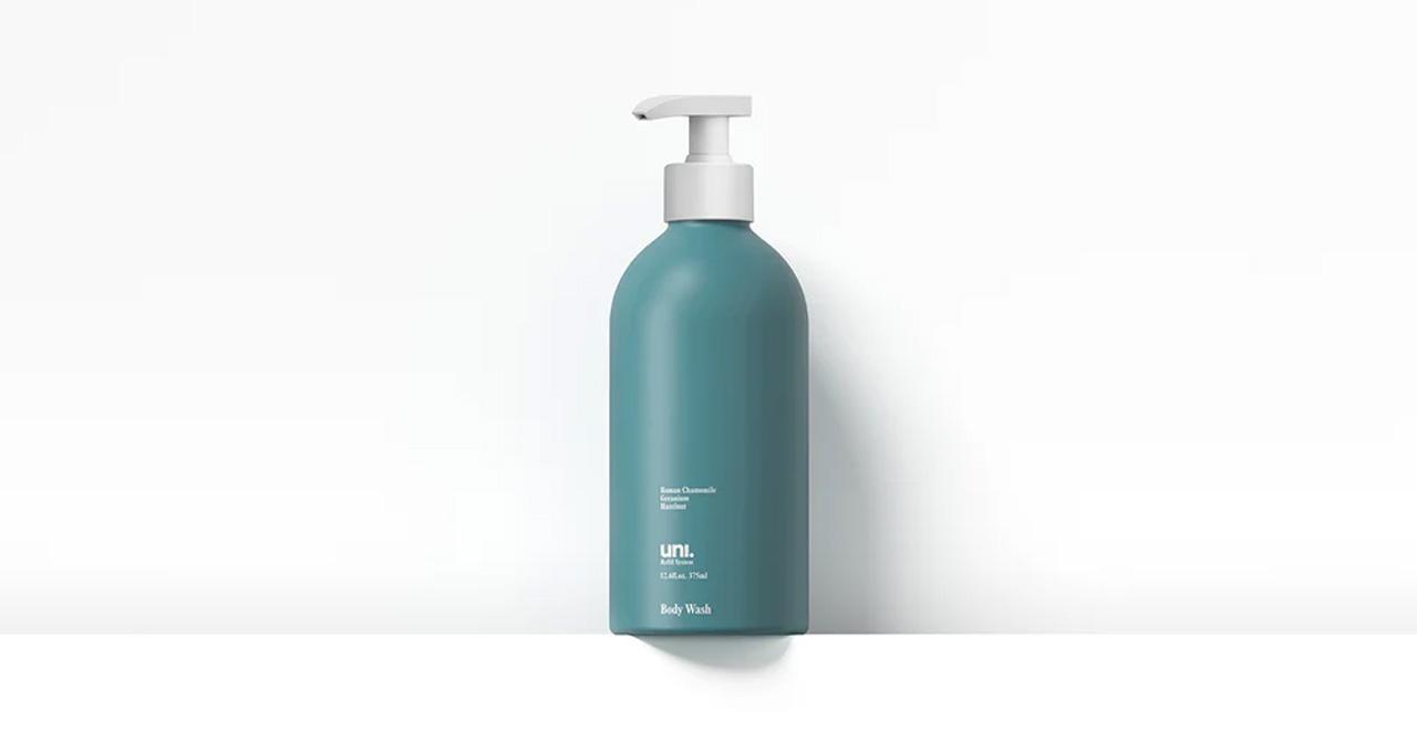 Uni organic body wash in green bottle on white ledge