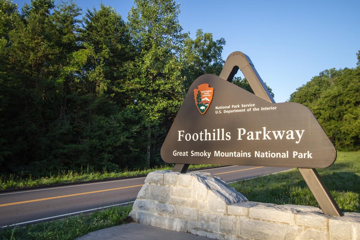 National park signage next to the roadway for the Foothills Parkway at the Great Smoky Mountains.