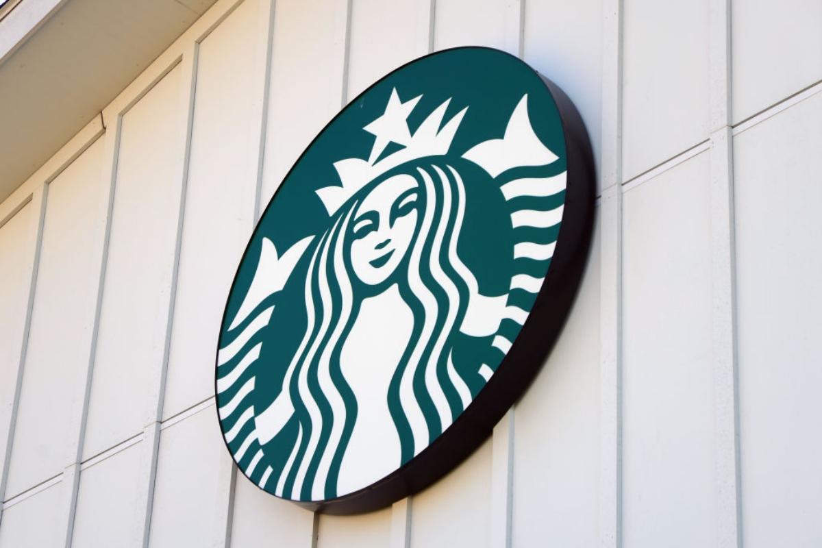 Starbucks siren logo against a white wall