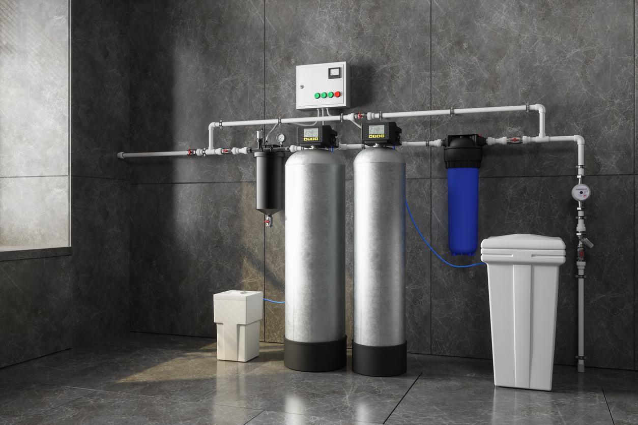 A water softening system is pictured in the garage of a residential home.