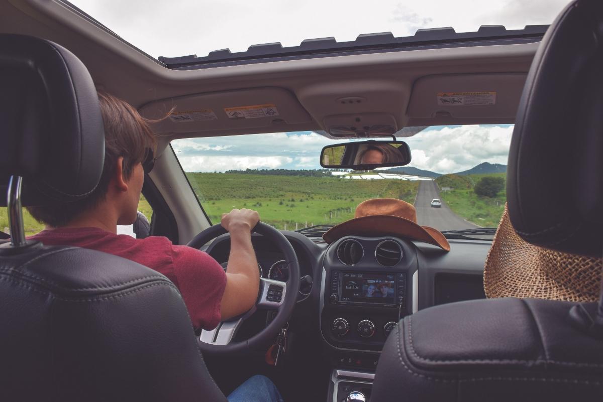 Young person driving in the country