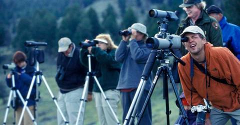 People gathered at a national park with their cameras and tripods for wildlife watching (Representative Cover Image Source: Getty Images | James Leynse)