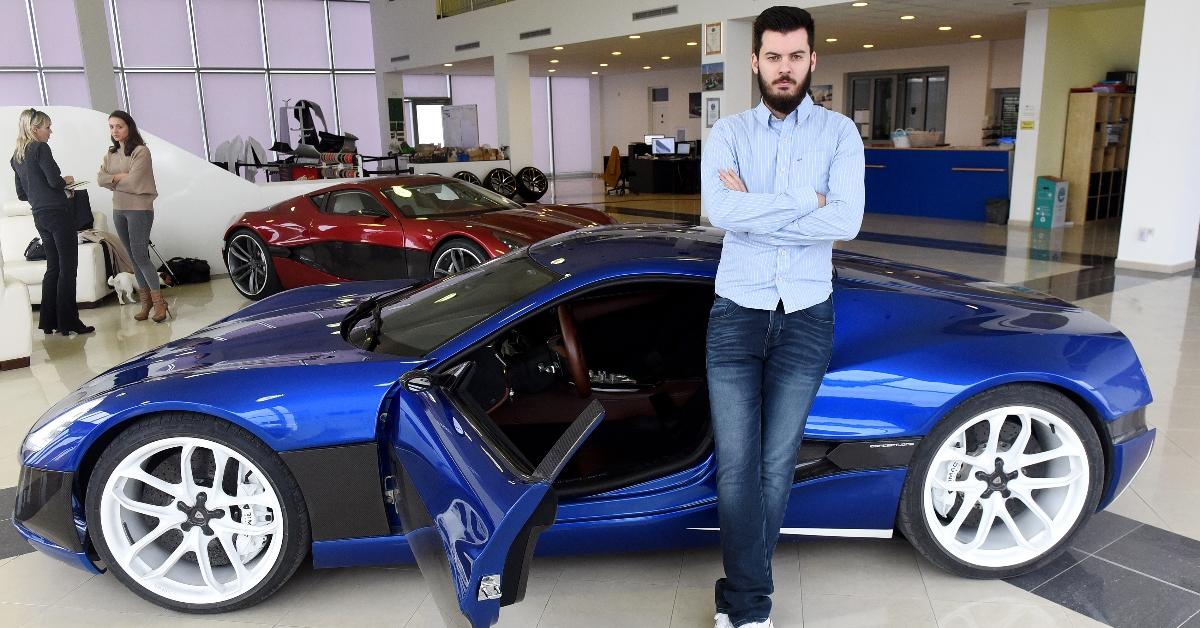 Mate Rimac, CEO of Bugatti-Rimac, stands next to his Concept One sportscar.