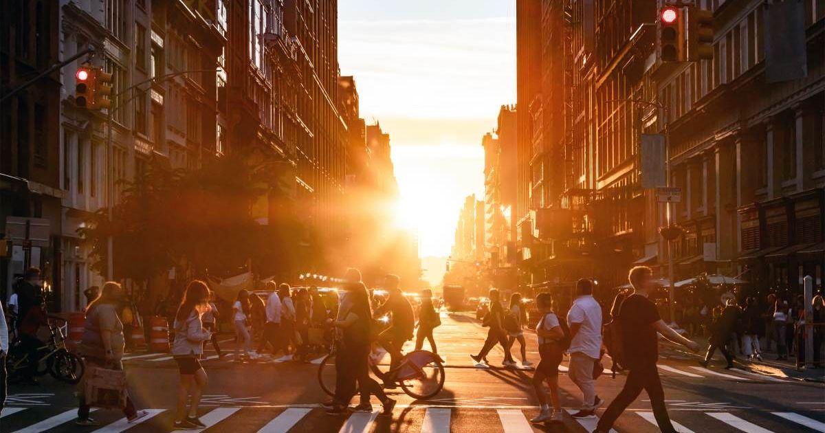 People walking through the busy intersection at 5th Avenue and 23rd Street in New York City on a summer day. (Representative Cover Image Source: Getty Images | Deberarr)