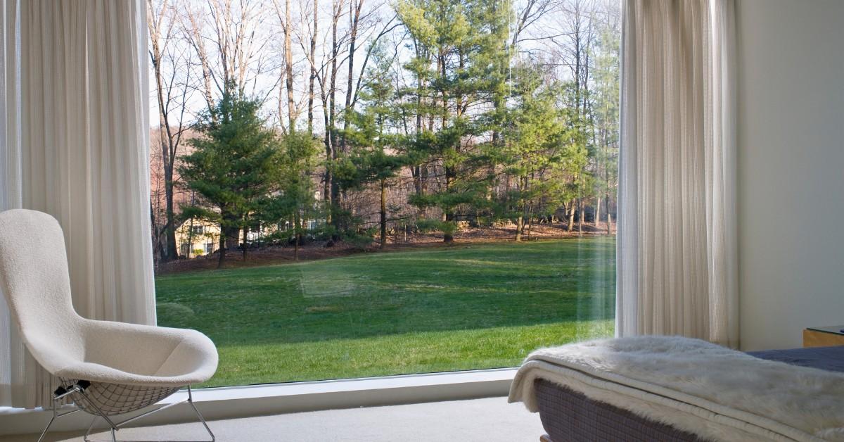 Wide shot of a floor to ceiling window inside a bedroom