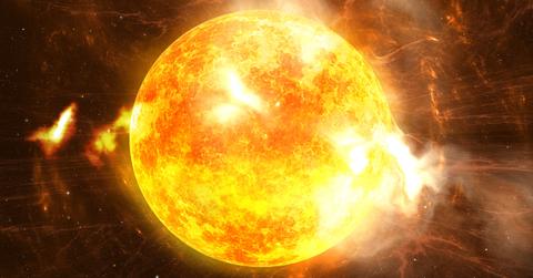 An orange-hued image of a solar flare.