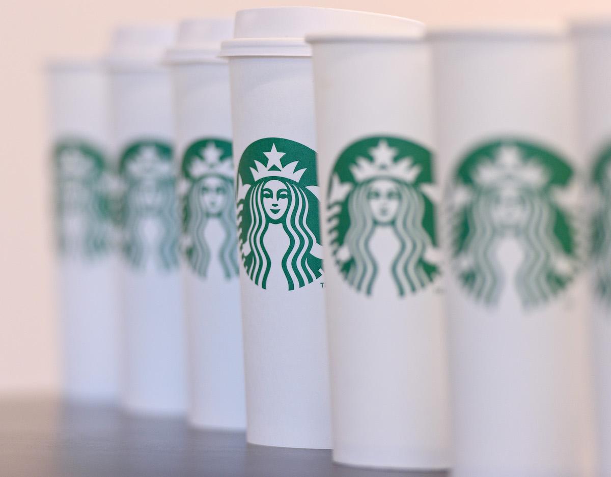 White paper Starbucks coffee cups in a line