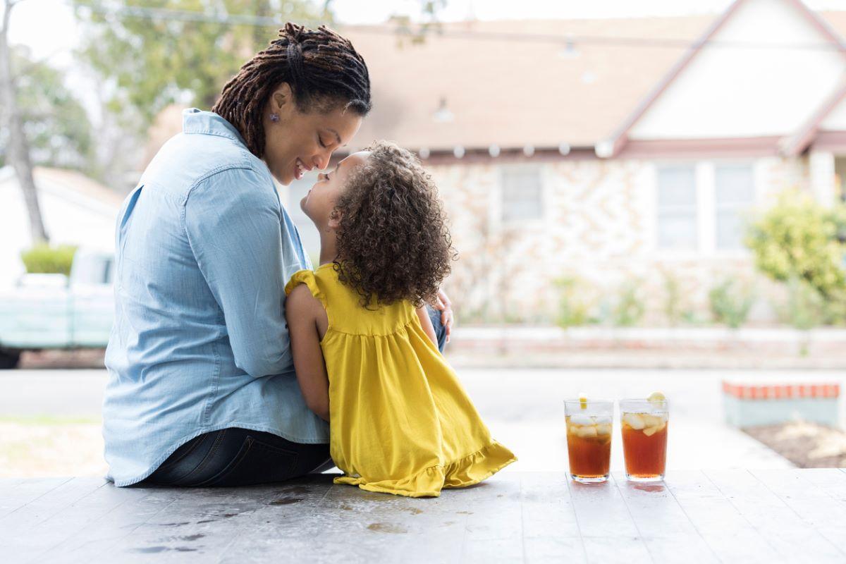 Mother and daughter sitting on the deck, enjoying sweet tea