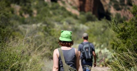 Visitors walking through towering mountain terrain in Big Bend National Park region (Representative Cover Image Source: Getty Images | Jennifer M Ramos)