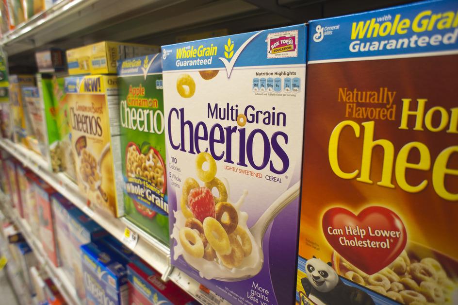 A line of Cheerios-brand cereals on the shelf at the store. 