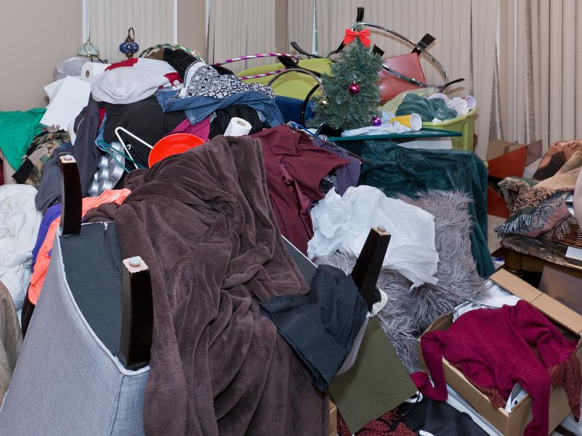 A pile of clothes and items that cover up an entire room.